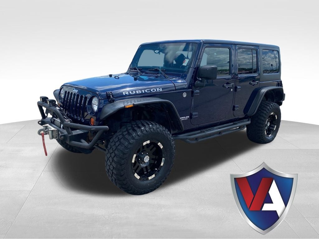 2013 Jeep Wrangler Unlimited Rubicon in True Blue Pearl — front three-quarter view